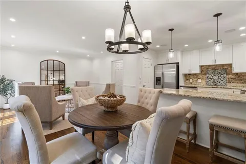 a kitchen with a dining table and chairs