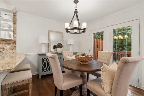 a view of a dining room with furniture wooden floor and chandelier