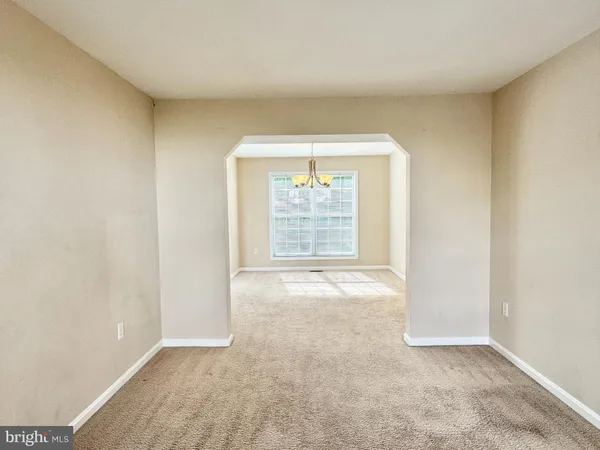 an empty room with closet and a bathroom