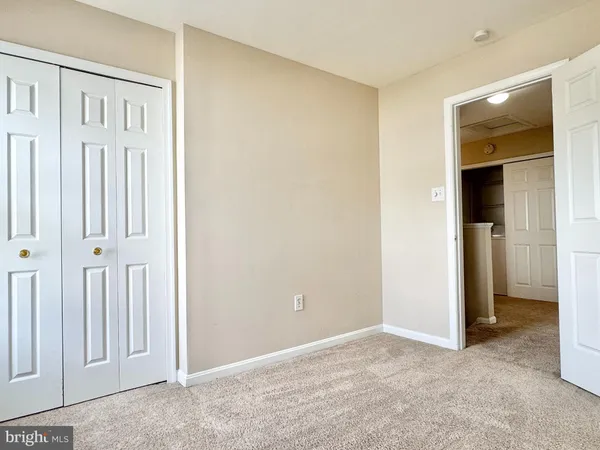 an empty room with a ceiling fan and a window