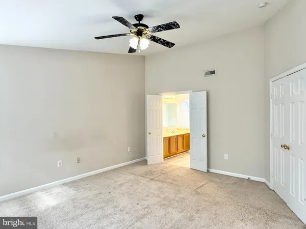 a view of an empty room with closet