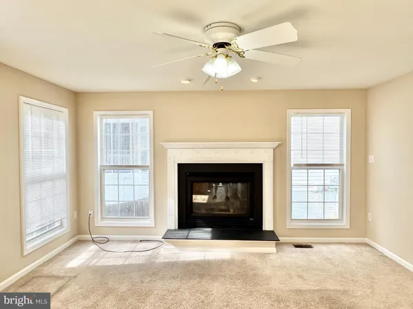 a living room with fireplace and a window