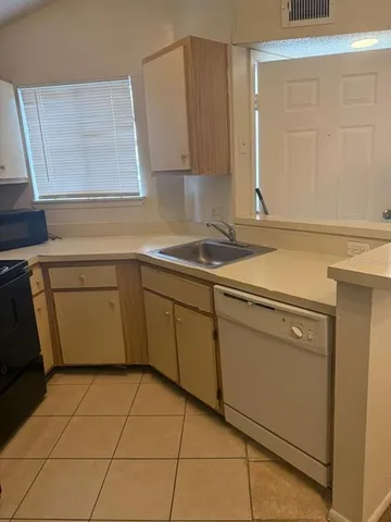 a kitchen with a sink cabinets and utility
