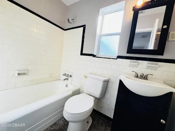 a bathroom with a sink toilet and mirror