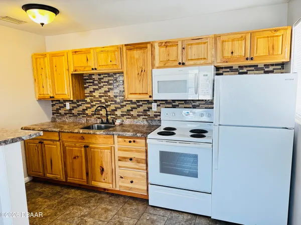 a kitchen with stainless steel appliances a stove sink and cabinets