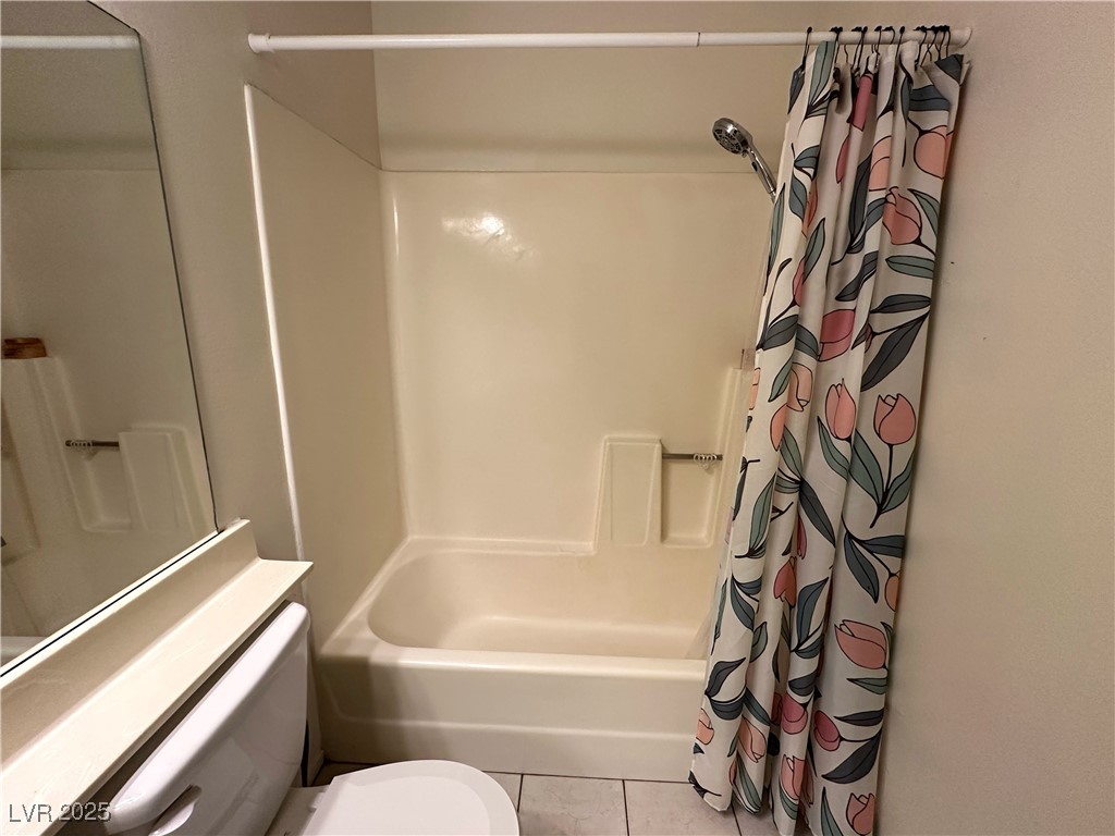 3936 Rive Gauche Street Las Vegas, NV 89115 - Photo 19 of 30 Full bathroom featuring shower / bath combination with curtain, tile patterned flooring, and toilet
