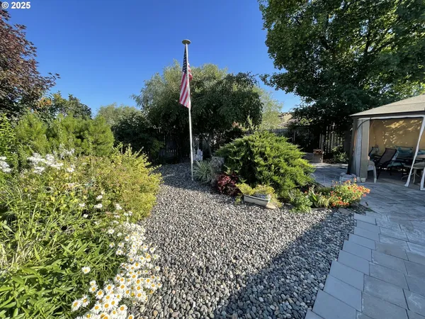 a view of a patio with table and chairs under an umbrella