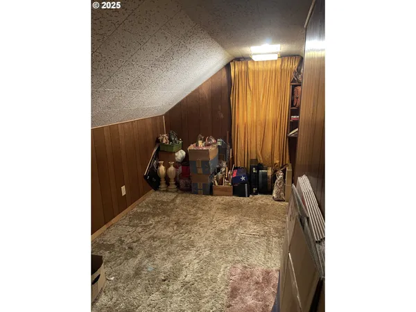a kitchen with a table chairs refrigerator and cabinets