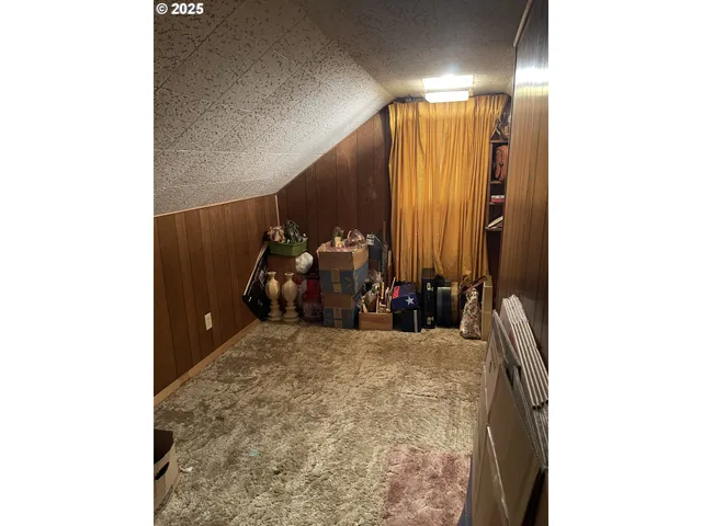 a kitchen with a table chairs refrigerator and cabinets