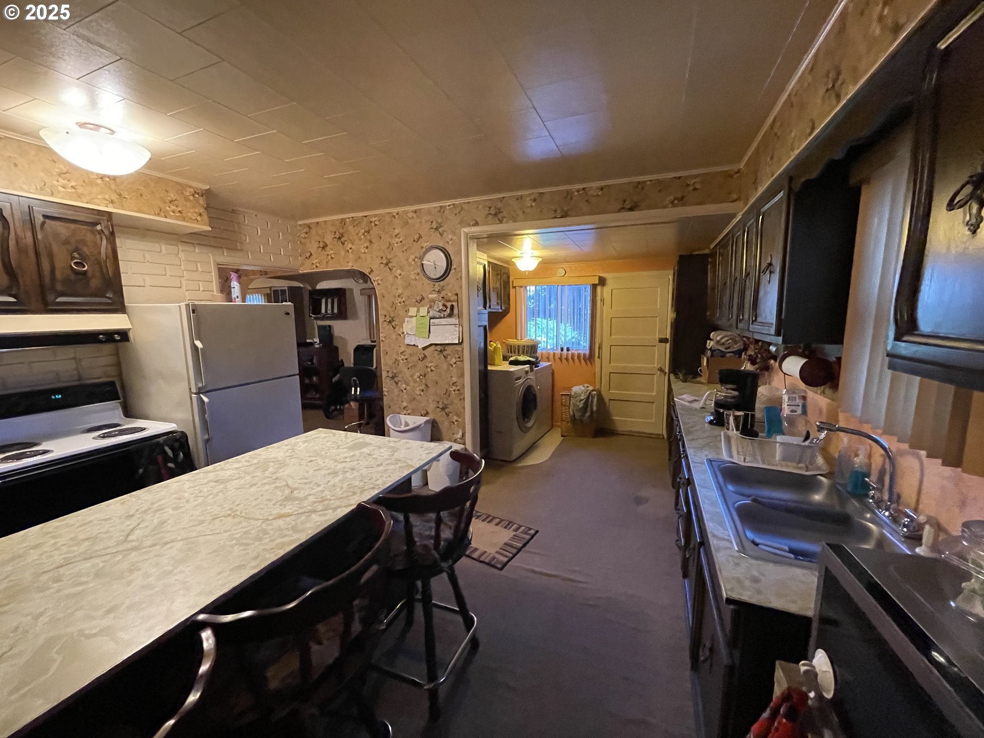 440 West Riverside Street Heppner, OR 97836 - Photo 10 of 22 a kitchen with a table chairs refrigerator and cabinets