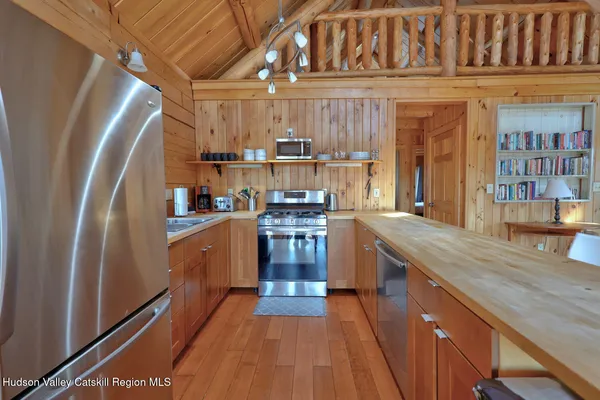 a bathroom with a sink a toilet a mirror and shower