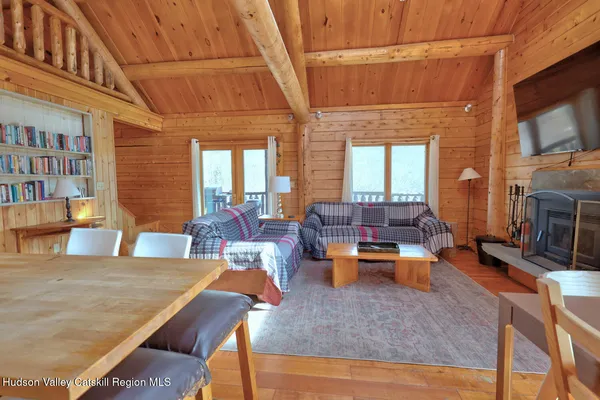 a living room with furniture pool table flat screen tv and couches