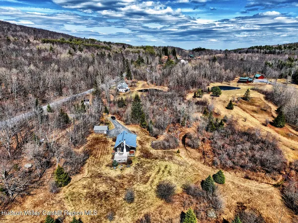 a backyard of a house with barbeque oven and outdoor seating