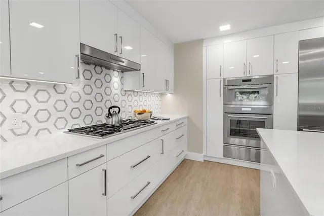 a living room with furniture a table and a large window