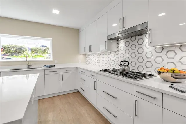 a living room with furniture a table and a large window