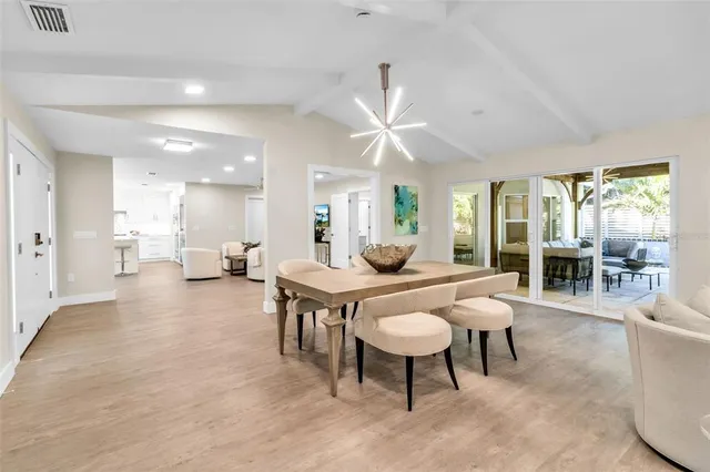 a living room with fireplace furniture and a large window