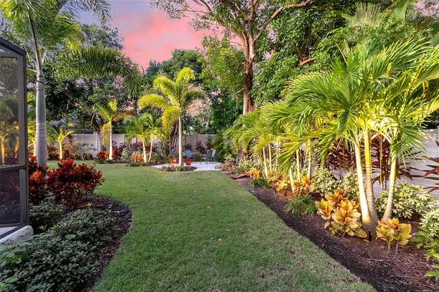 a view of a house with a big yard and potted plants