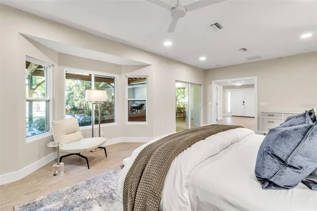 a bathroom with a granite countertop sink a toilet and a mirror