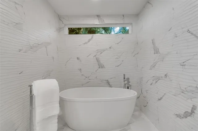 a spacious bedroom with a large bed and a couch