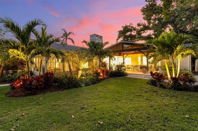 a view of a patio with a table and chairs under an umbrella