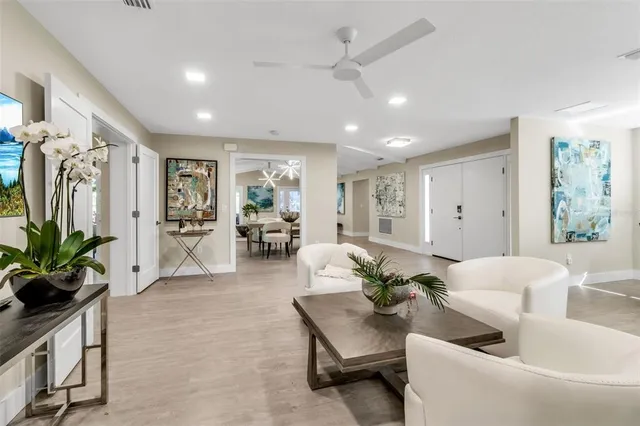 a view of a dining room with furniture a rug and wooden floor