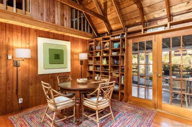 a dining room with a wooden table and chairs
