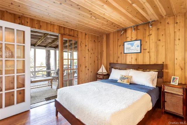 a bedroom with a large bed and a large window