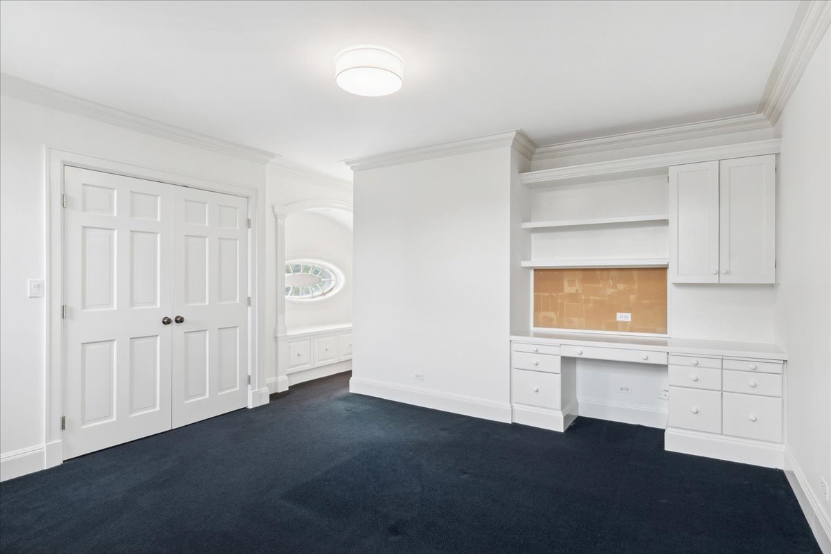 126 Hazel Avenue Glencoe, IL 60022 - Photo 29 of 44 a view of an empty room with a window and wooden floor