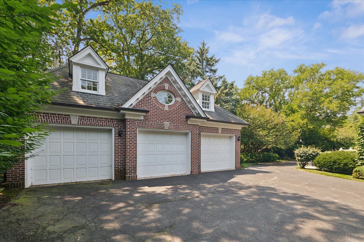 126 Hazel Avenue Glencoe, IL 60022 - Photo 35 of 44 a front view of a house with a yard and garage