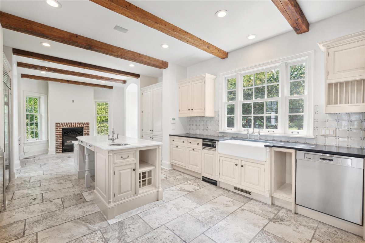 126 Hazel Avenue Glencoe, IL 60022 - Photo 10 of 44 a large white kitchen with granite countertop a white cabinets and chairs