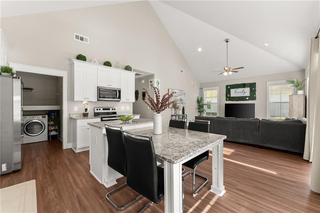 230 Campbell Street Cleveland, GA 30528 - Photo 11 of 37 a kitchen with kitchen island a counter top space a sink stainless steel appliances and cabinets