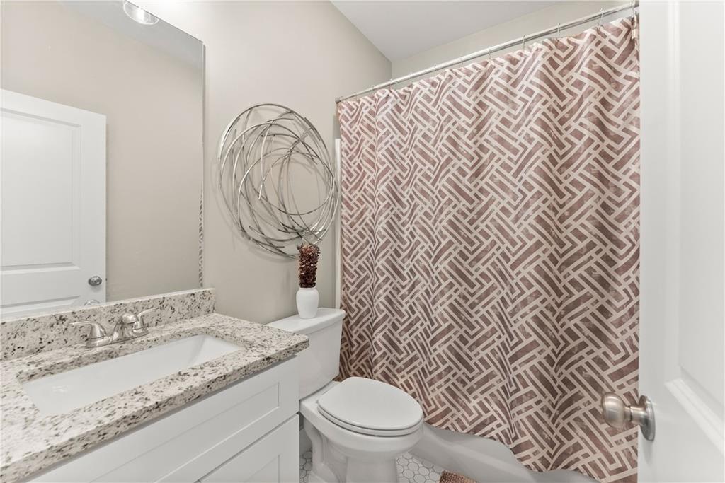 230 Campbell Street Cleveland, GA 30528 - Photo 16 of 37 a bathroom with a granite countertop sink and a toilet