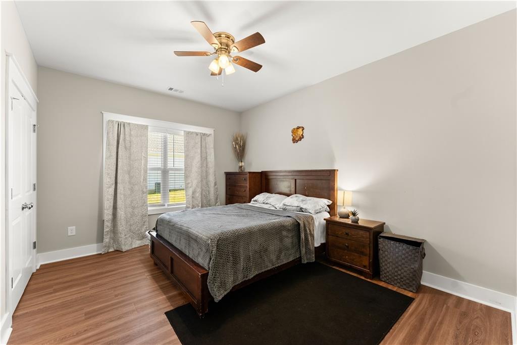 230 Campbell Street Cleveland, GA 30528 - Photo 17 of 37 a bedroom with a bed and wooden floor