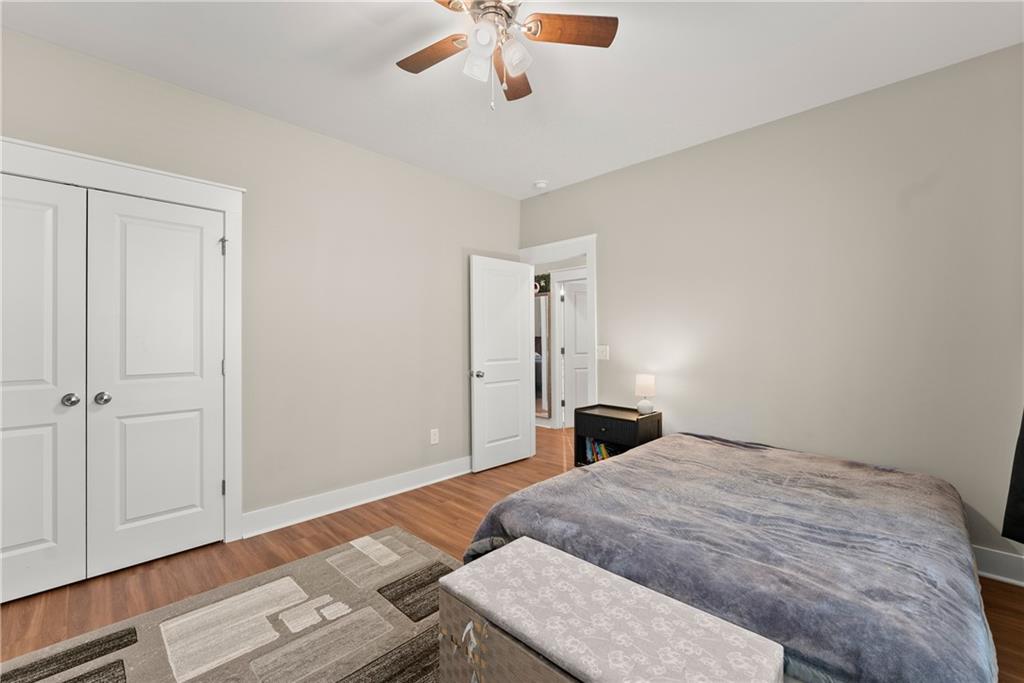 230 Campbell Street Cleveland, GA 30528 - Photo 20 of 37 a bedroom with a bed and a chandelier fan