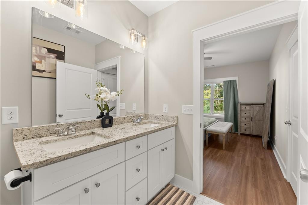 230 Campbell Street Cleveland, GA 30528 - Photo 26 of 37 a en suite bathroom with a granite countertop sink and a mirror
