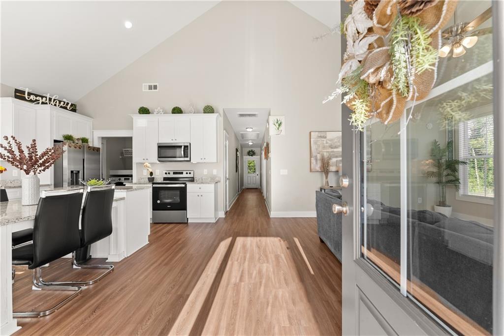 230 Campbell Street Cleveland, GA 30528 - Photo 6 of 37 a view of a kitchen with kitchen island wooden floor and stainless steel appliances