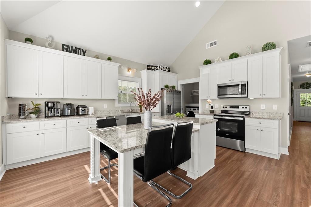 230 Campbell Street Cleveland, GA 30528 - Photo 7 of 37 a kitchen with granite countertop a sink cabinets and stainless steel appliances