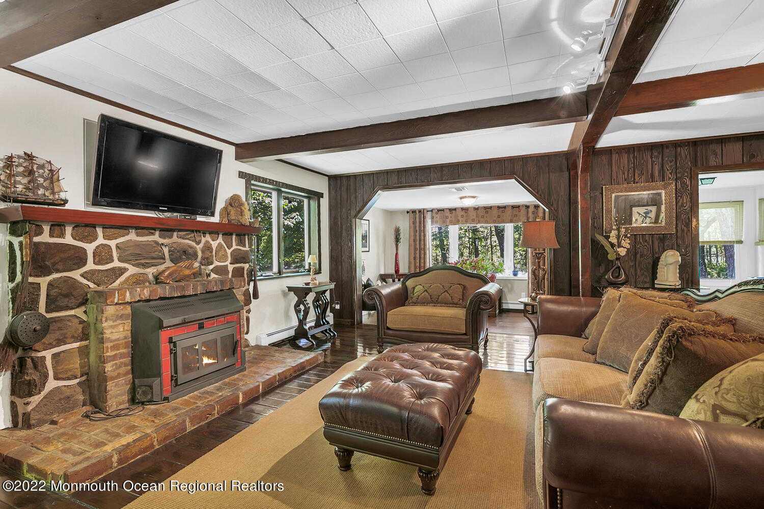 104 Peskin Road Farmingdale, NJ 07727 - Photo 30 of 54 a living room with furniture a flat screen tv and a fireplace