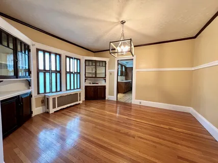 a view of a room with wooden floor and windows