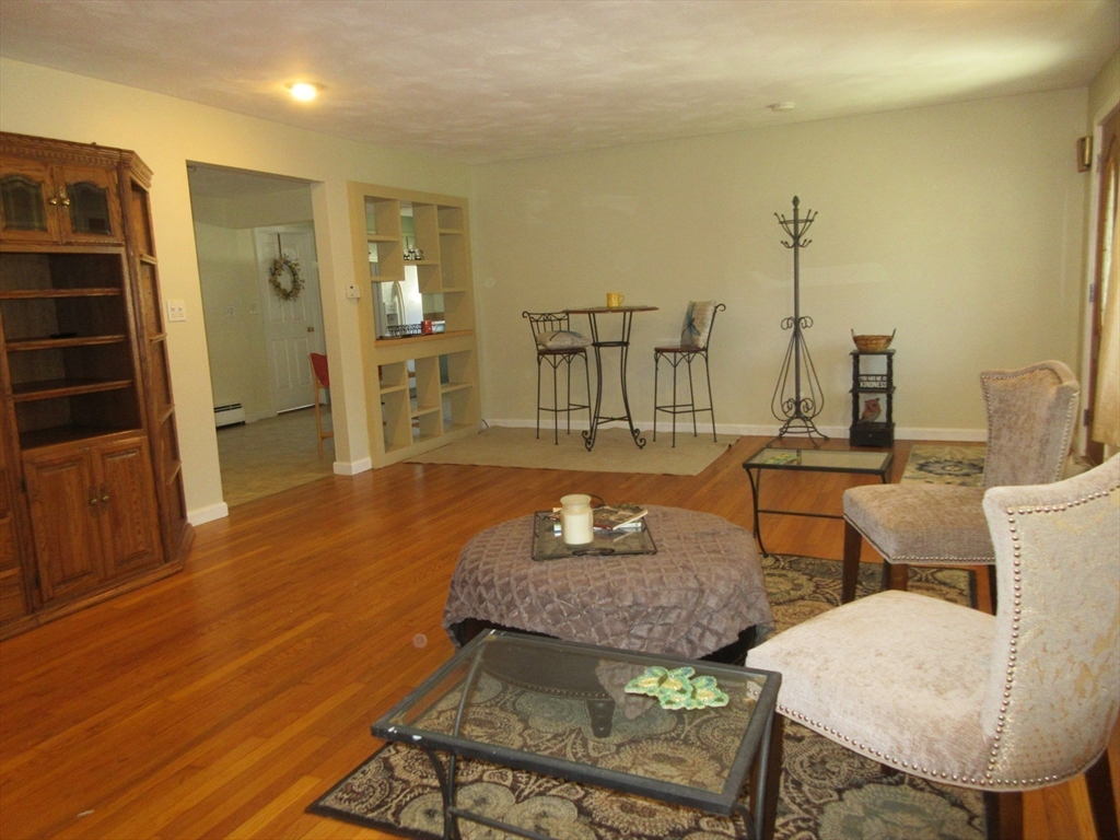 13 Sutton Place Easthampton, MA 01027 - Photo 10 of 31 a living room with furniture a wooden floor and next to a window