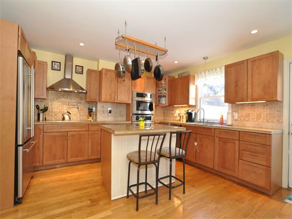 2 Ward Court Boston, MA 02127 - Photo 5 of 15 a kitchen with stainless steel appliances granite countertop a refrigerator and wooden cabinets