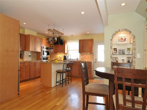 2 Ward Court Boston, MA 02127 - Photo 6 of 15 a kitchen with stainless steel appliances kitchen island granite countertop a table chairs microwave and cabinets