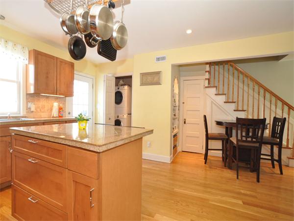 2 Ward Court Boston, MA 02127 - Photo 7 of 15 a kitchen with stainless steel appliances kitchen island granite countertop a table chairs in it and wooden floors