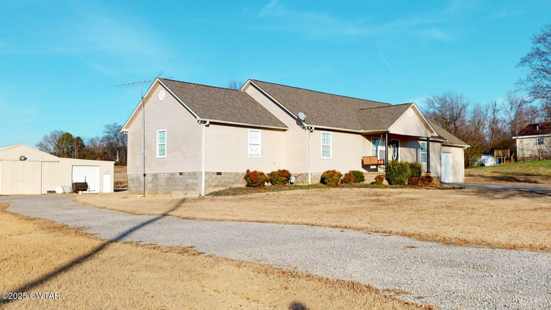 a view of a house next to a road and yard