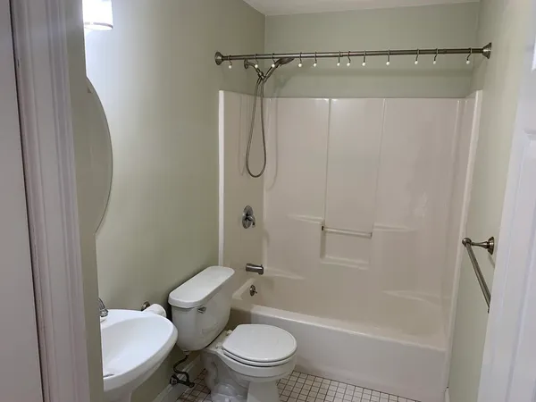 a bathroom with a toilet and a shower