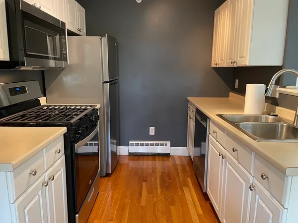 a kitchen that has a sink and a stove