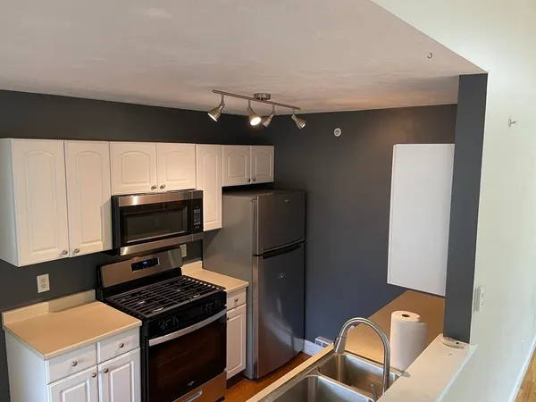 a kitchen with a refrigerator stove and microwave