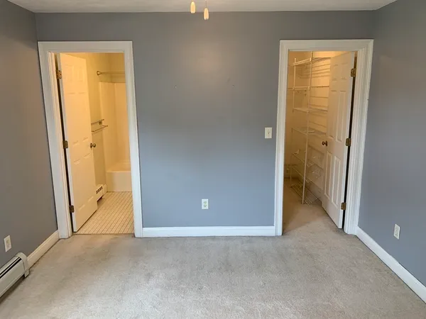 an empty room with windows and closet