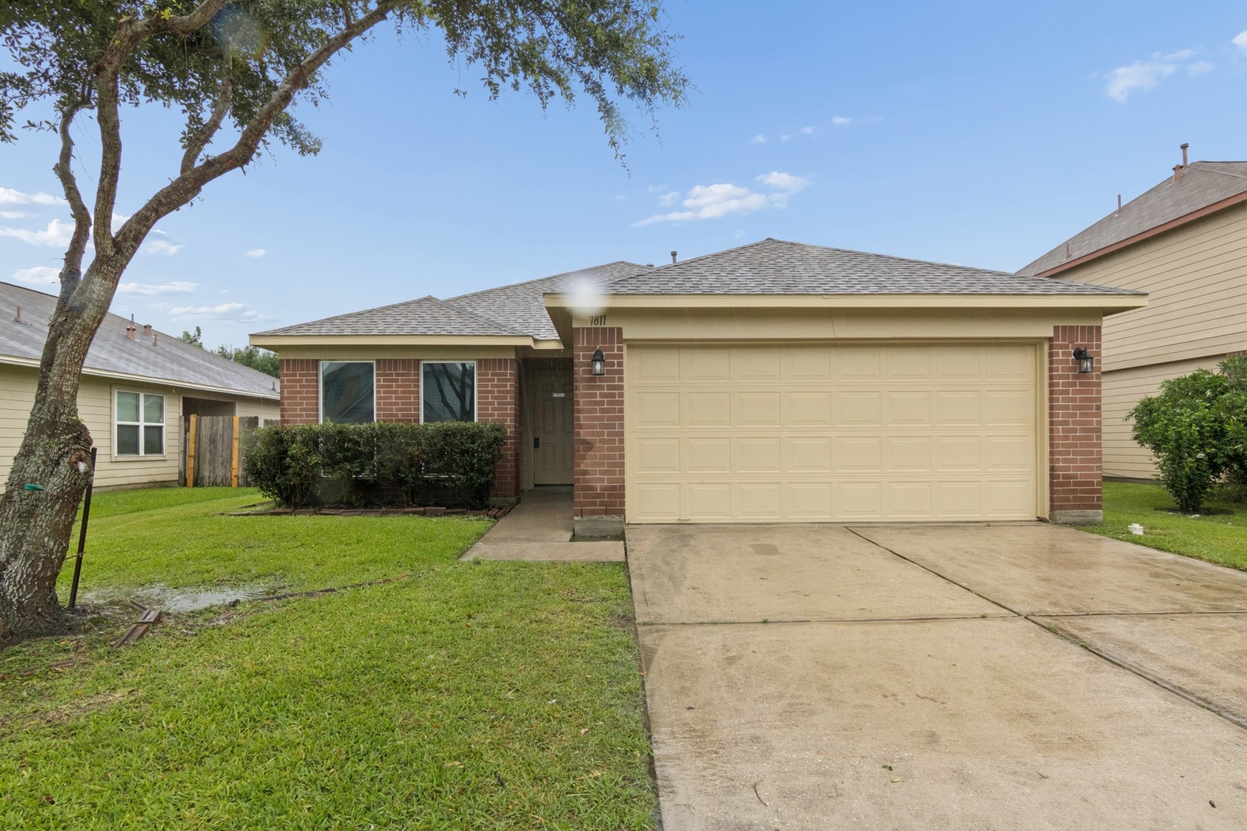 7811 Adonis Avenue Baytown, TX 77521 - Photo 1 of 36 a front view of a house with a yard and garage