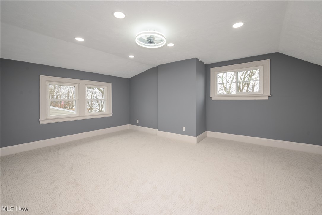 17728 Windward Road Cleveland, OH 44119 - Photo 17 of 32 Bonus room featuring plenty of natural light, carpet flooring, and vaulted ceiling